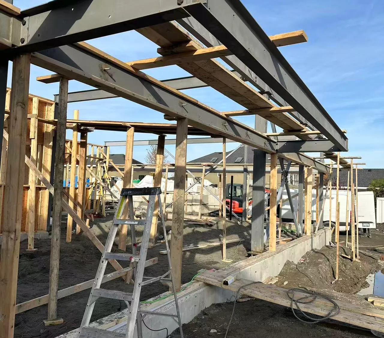 A Titrin build under construction, steel and timber framing against a blue sky